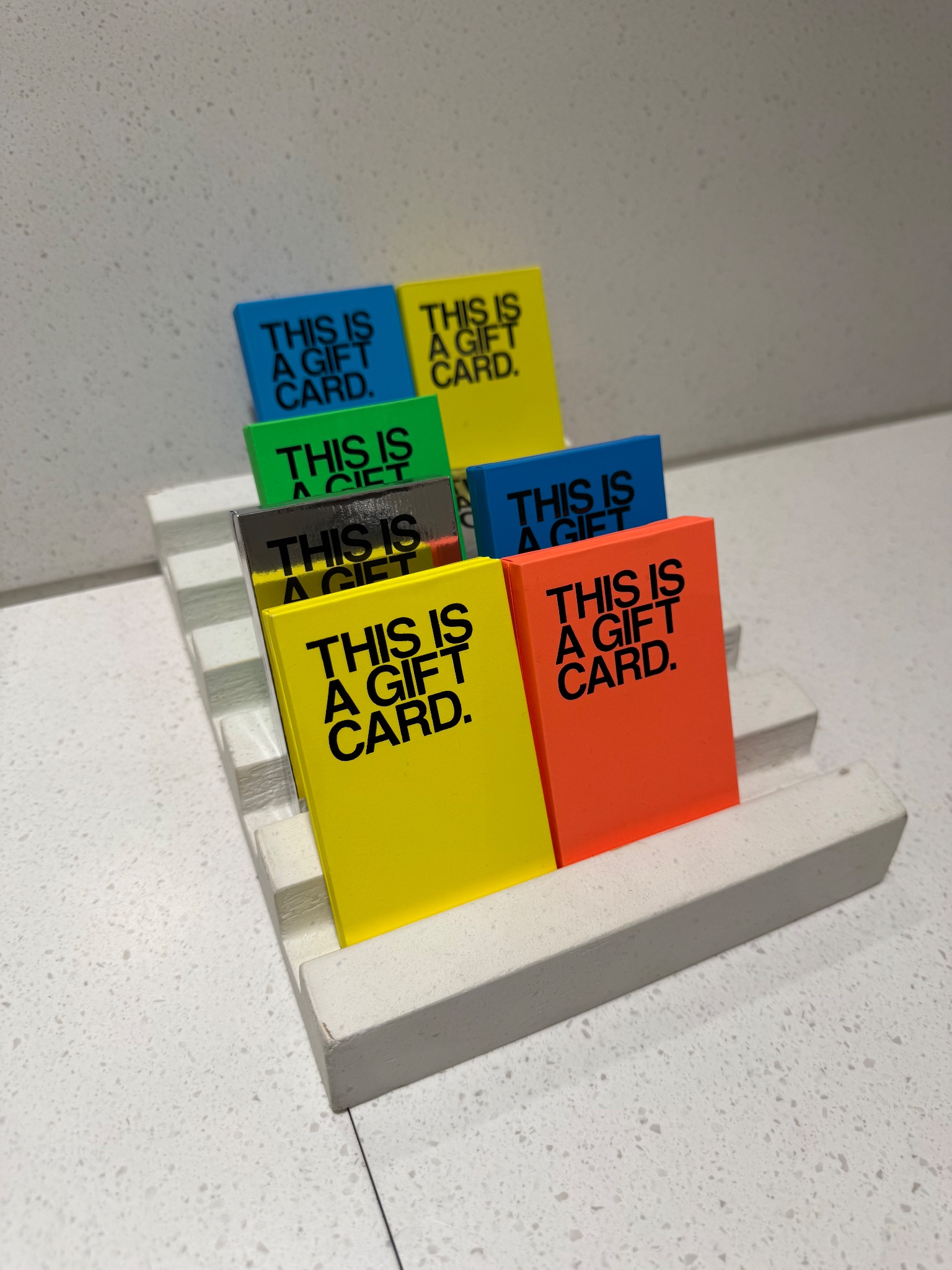 This is a gift card in neon Helvetica, Stratford