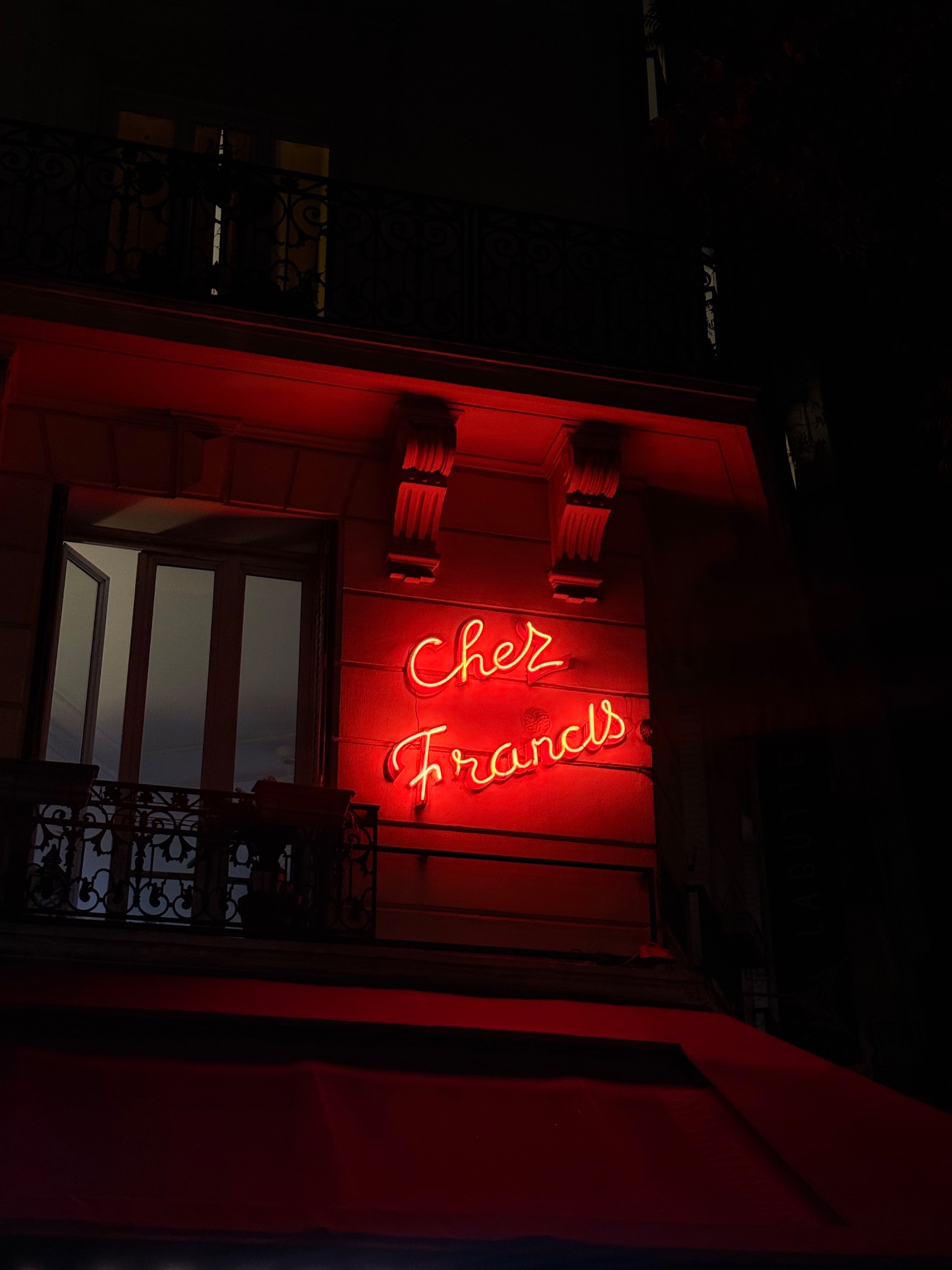 Red neon script for Chez Francis, Paris