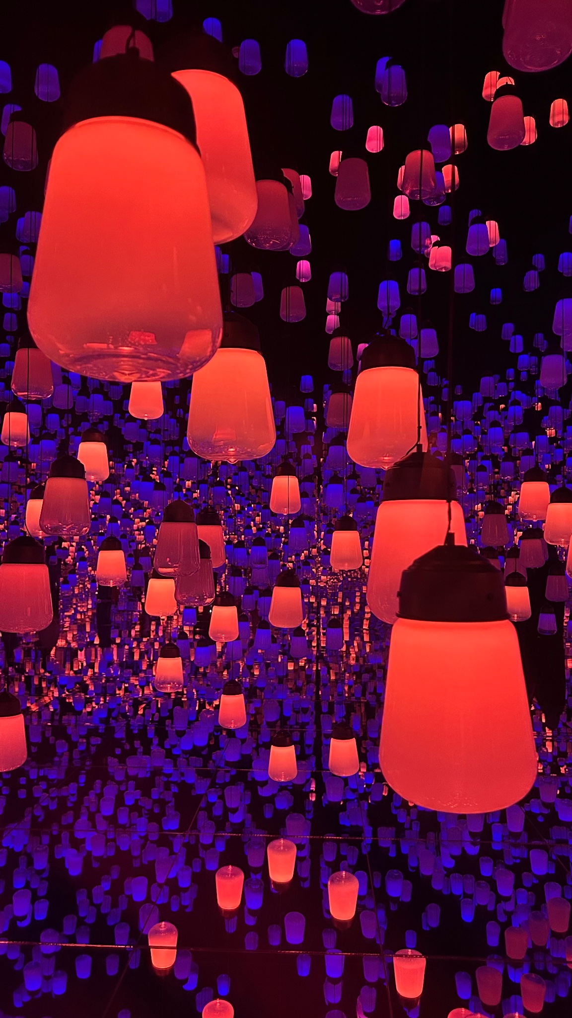 Glowing red and violet lamps in mirrored infinity, Jeddah